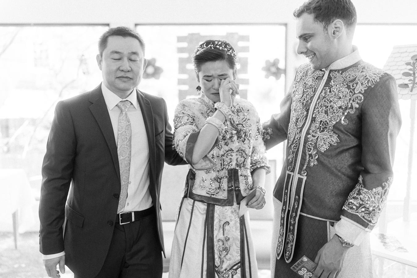 Rawle comforts a tearful Miffy beside a suited man during their Chinese tea ceremony at Ancaster Mill.