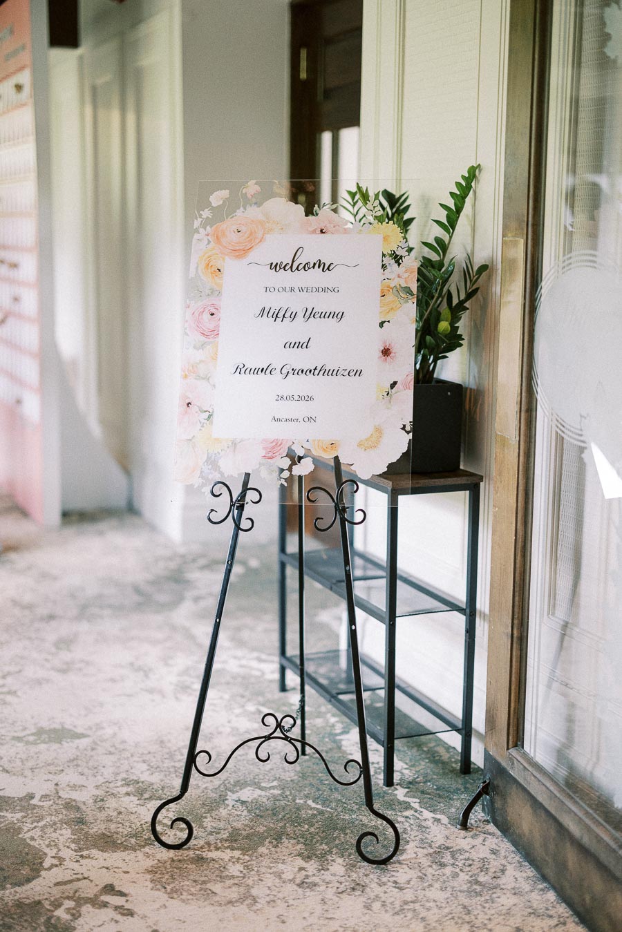 Floral welcome sign on an easel for Miffy and Rawle’s wedding in Ancaster, Ontario.