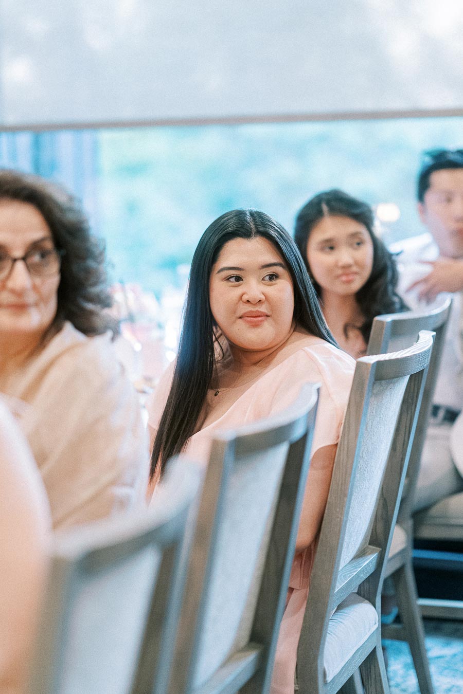 Wedding guests seated in chairs during an indoor reception at Ancaster Mill
