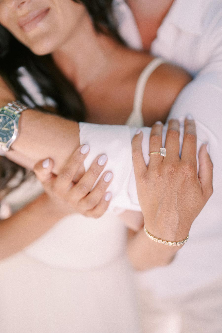 Rachel’s engagement ring rests on Matt’s sleeve as they hold each other in a close embrace.