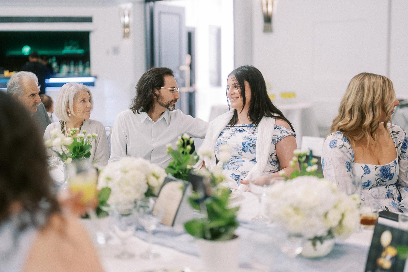 Guests seated at a decorated table during a family celebration.