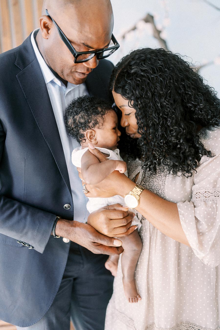 Karina kisses baby Isabella while Terence holds them close at home in Toronto.