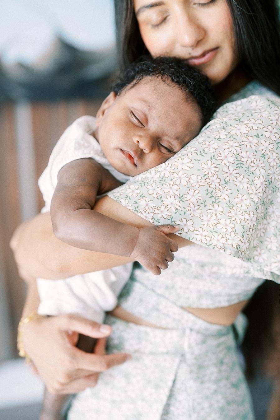 Karina holds sleeping newborn Isabella against her shoulder in their Toronto home.
