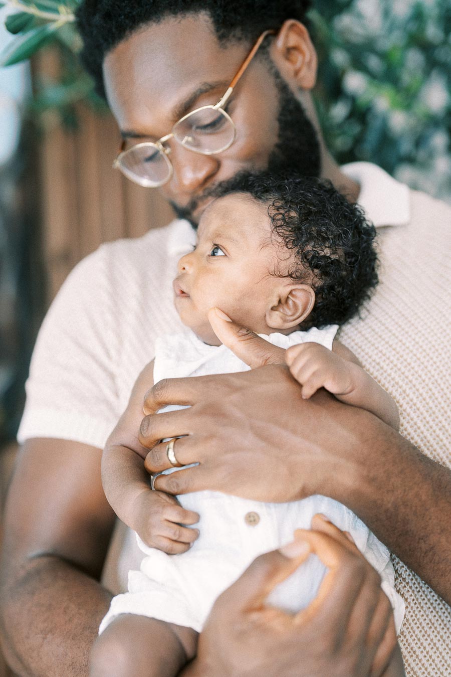 Terence holds baby Isabella as she looks up in their Toronto home.