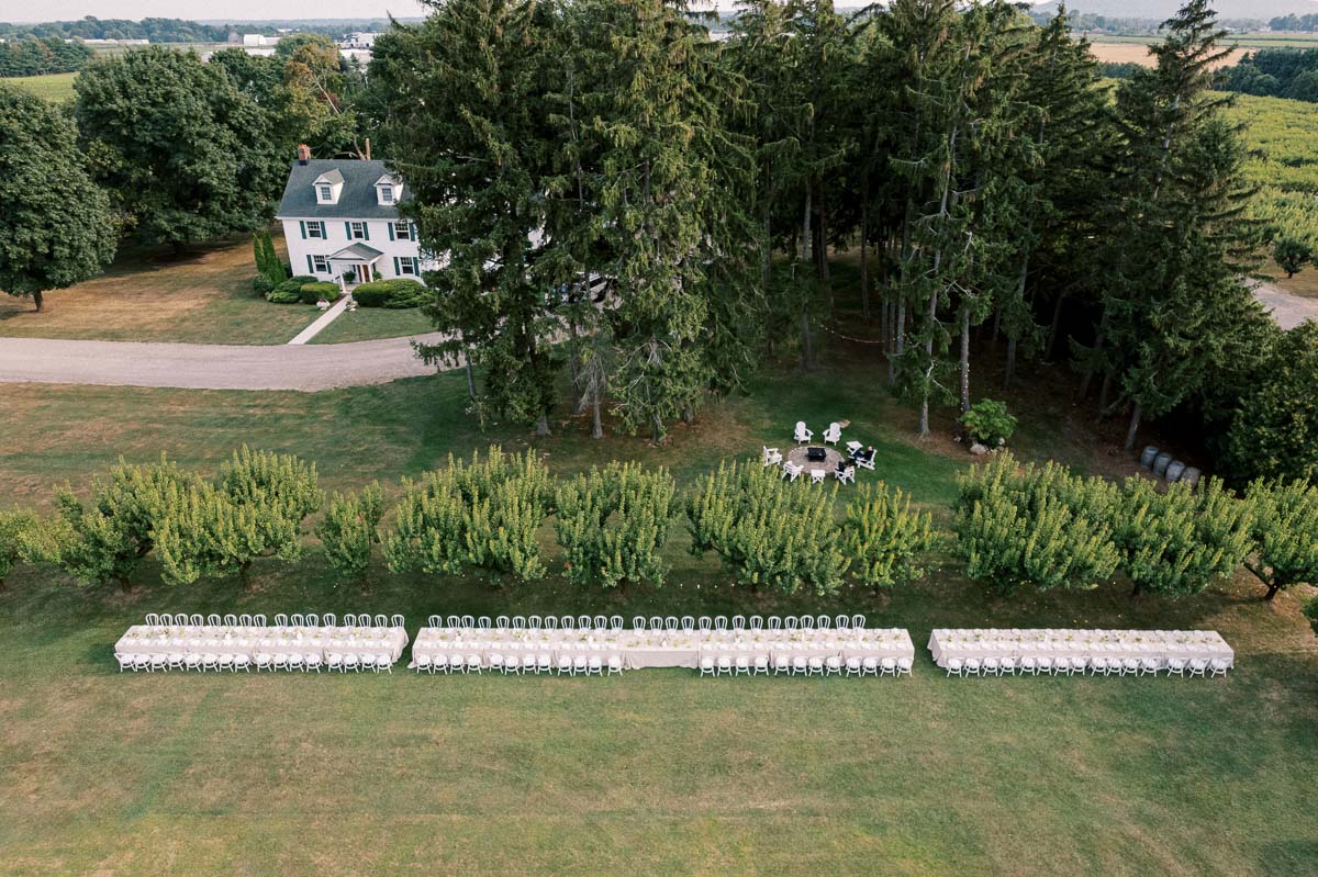 A drone view of the long-table dinner and farmhouse at Martin Estates during a Niagara wedding.