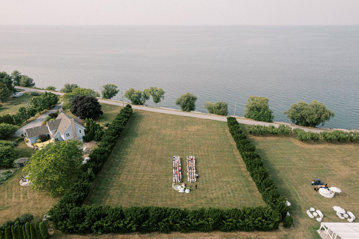 Aerial wedding photography showing Martin Estates, its ceremony lawn and the Lake Ontario shoreline in Niagara.
